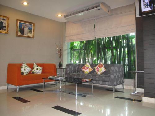 a living room with a couch and a table at 14 Resort in Bangkok