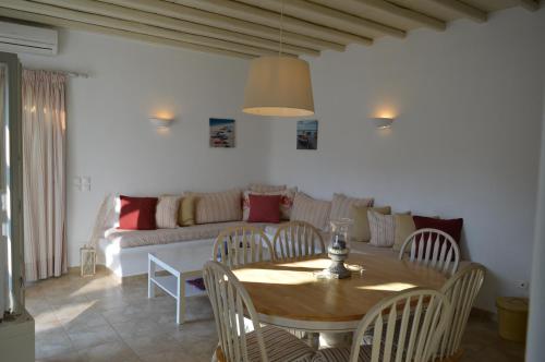 a living room with a table and a couch at Sea Side Studios & Houses in Kalo Livadi