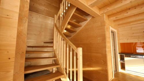 a wooden staircase in a log cabin at Ferienwohnung Zillertal - Schwemberger in Fügen