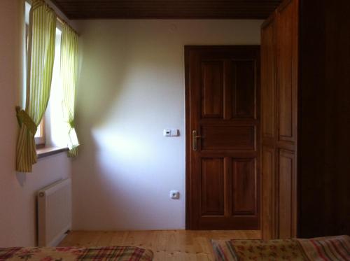 an empty room with a door and a window at Penzion Terezka in Králíky
