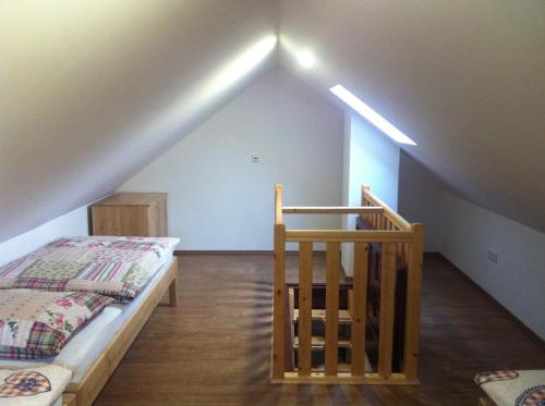 a attic room with a bed and a staircase at Penzion Terezka in Králíky