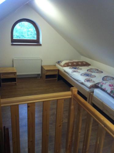 a room with two beds and a window at Penzion Terezka in Králíky