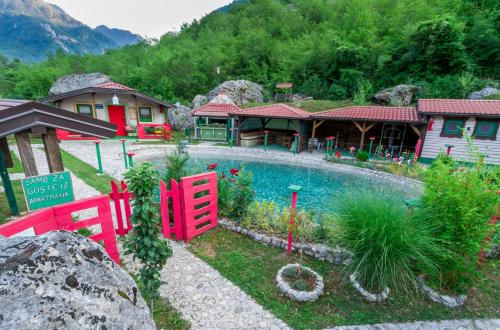 a house with a swimming pool in a yard at Eco village Raj u raju in Konjic