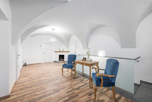 a room with a table and chairs and a fireplace at Hotel "City Rooms Wels" in Wels