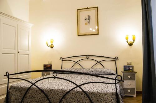 a bedroom with a bed and two lights on the wall at B&B Domus Piazza del Popolo in Rome