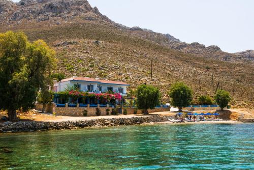 a house on the shore of a body of water at Faros Rooms in Livadia