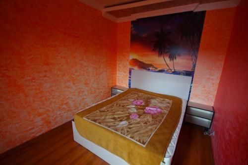 a bed in a room with a painting on the wall at Oasis GASAMANIA in Batumi
