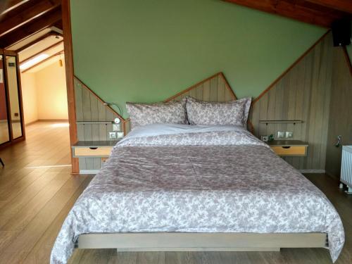 a bedroom with a large bed and two tables at Oresivio in Metsovo