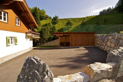 a garage with a stone wall next to a building at Chalet Jagdhof in Sankt Johann im Pongau