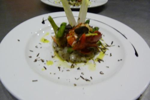 a white plate with a dish of food on it at Le Prieuré des Sources in La Répara