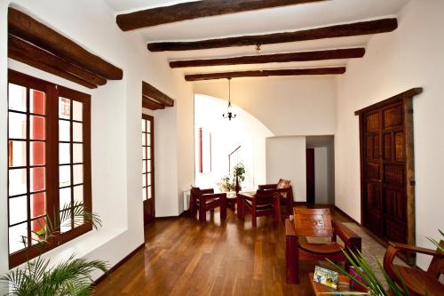 an open living room with a table and chairs at Hotel Villa Antigua in Sucre
