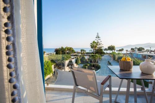 a balcony with a table and a view of the ocean at Athina Studios and Suites Plaka in Plaka