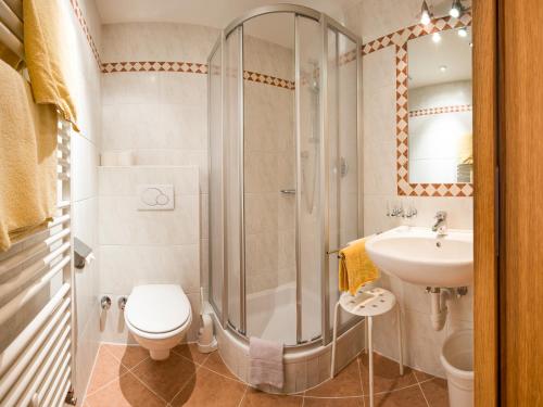a bathroom with a shower and a toilet and a sink at Ferienhaus Pension Gulla in Neustift im Stubaital
