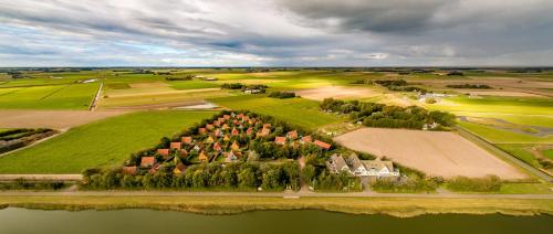 an aerial view of a farm with houses and trees at Prins Hendrik Texel in Oost
