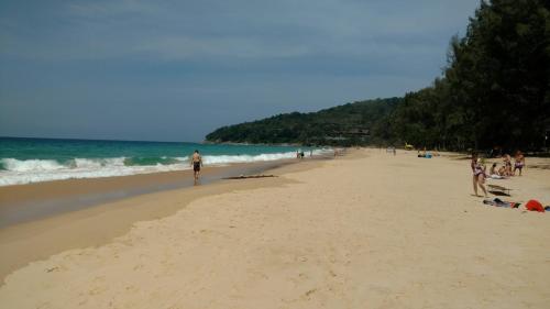 a group of people standing on a beach at Naithon condominium A-103 in Nai Thon Beach