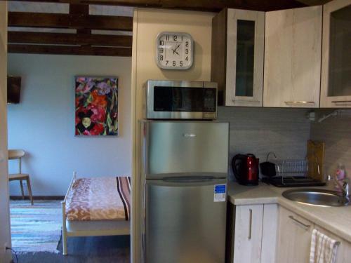 a kitchen with a microwave on top of a refrigerator at Kelluka Holiday House in Pärispea