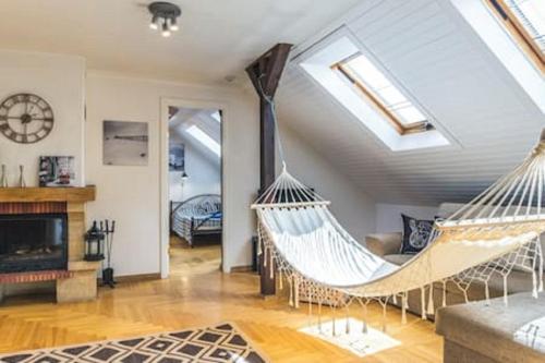 a living room with two hammocks in a house at Old Riga Romantic Loft in Riga