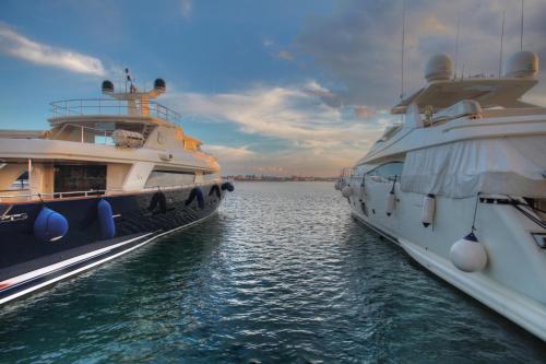 two large boats are docked in the water at Boutique Apartments Ad Astra in Bibinje