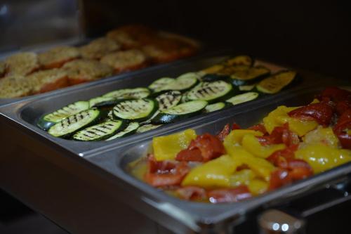 a tray of food with cucumbers and other vegetables at Best Western Plus Soave Hotel in San Bonifacio