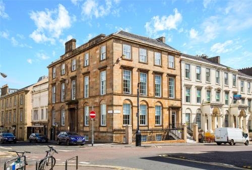 a large brick building on the corner of a street at Blythswood Square Apartments in Glasgow