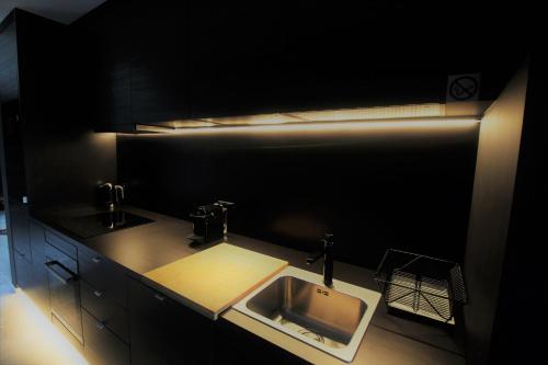 a kitchen with a sink and a counter top at Oduo in Sart-lez-Spa