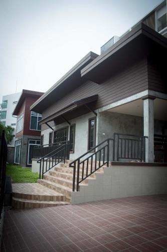 a house with stairs in front of it at PK Villa Huahin in Hua Hin