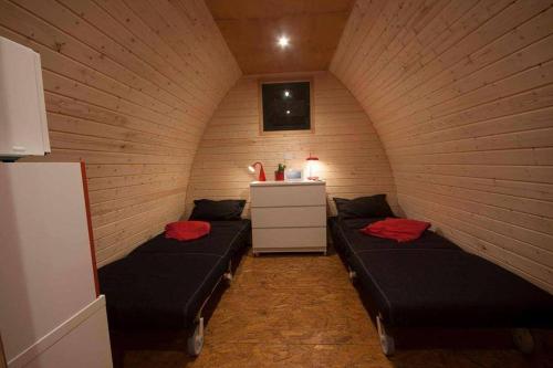 a room with two beds and a dresser at Solmeco Park in Aldeia do Meco