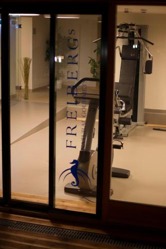 a view of a gym through a window at Seevilla Freiberg in Zell am See