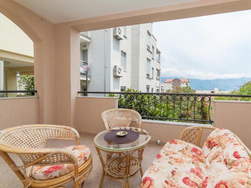 a balcony with a couch and chairs and a table at Apartments Spin in Budva