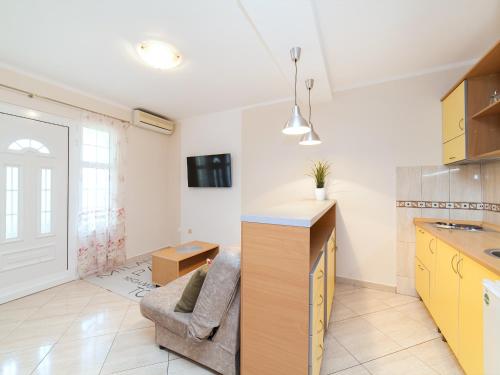 a kitchen and living room with a couch and a table at Apartments Spin in Budva