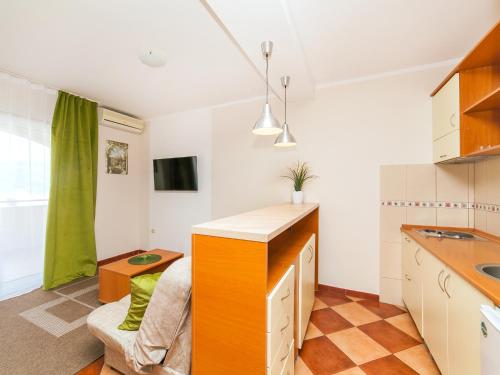 a kitchen with a counter and a couch in a room at Apartments Spin in Budva