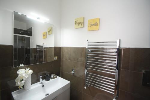 a bathroom with a sink and a mirror at CASA FELICE Suite Room in Taranto