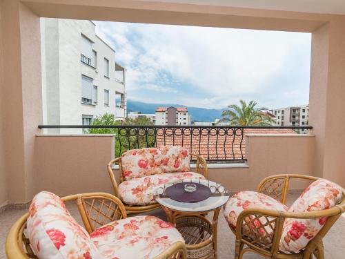 a balcony with chairs and a table on a balcony at Apartments Spin in Budva