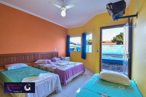 A bed or beds in a room at Pousada Lua de Tomate