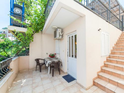 a patio with a table and chairs and stairs at Apartments Spin in Budva