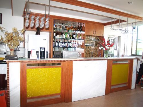 a bar with a yellow and white counter top at Evergreen Hotel in Antananarivo