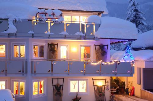 a house with a christmas tree on the balcony at Appartementhaus Charisma in Fieberbrunn