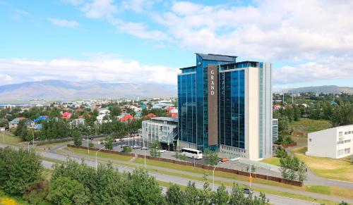 a tall glass building in a city with a road at H&oacute;tel Reykjav&iacute;k Grand in Reykjav&iacute;k