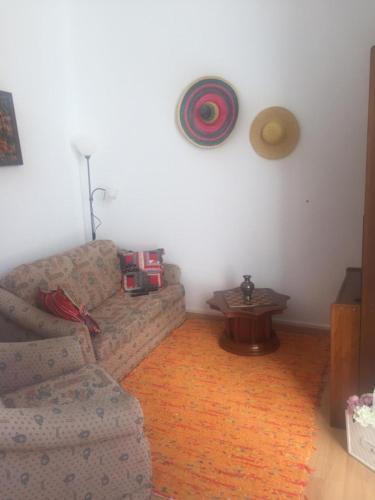 a living room with a couch and a table at Olive Street House in Coimbra
