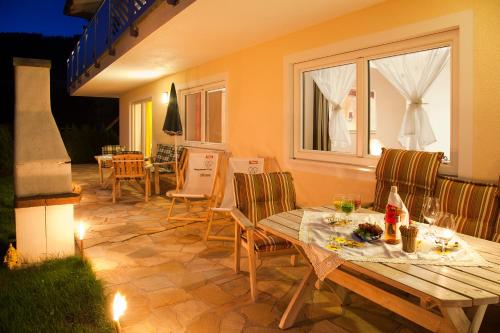 a patio with a table and chairs and a window at Appartementhaus Charisma in Fieberbrunn