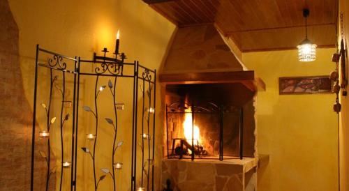 a room with a stone fireplace with a fire place at Rincon de Luna in Cuenca