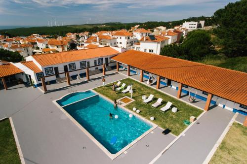 an aerial view of a house with a swimming pool at Zulla Nazaré`s Surf Village in Nazaré