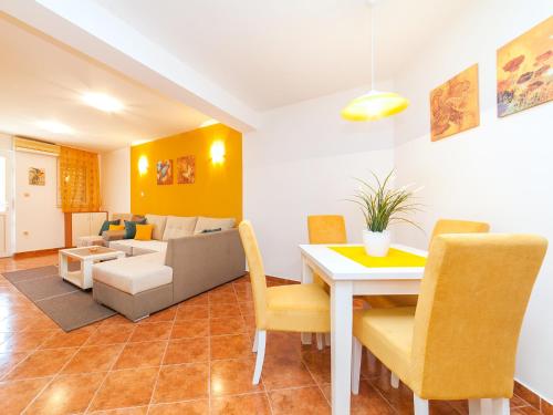 a living room with a table and a couch at Apartments Spin in Budva