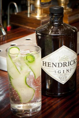 a bottle of harpenden gin next to a glass of water at The Lamplighter Dining ~ Rooms in Windermere