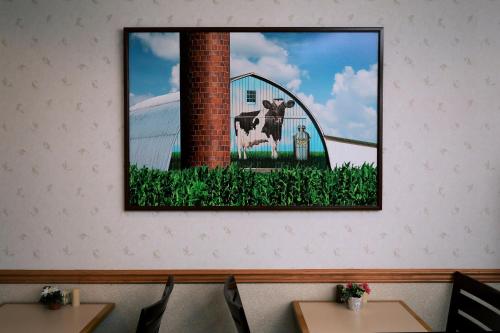 a picture of a cow in a barn on a wall at Lancaster Inn & Suites in Manheim
