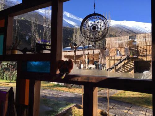 a window with a view of a snow covered mountain at Hotel Faro del Valle in Pisco Elqui