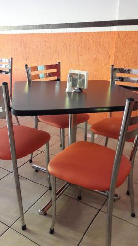a black table and chairs with red chairs at Hotel La Torre San Francisco in San Francisco del Rincón