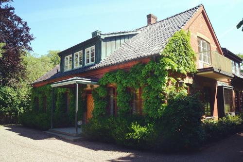 a house with ivy growing on the side of it at Minnesberg Bed & Breakfast in Trelleborg
