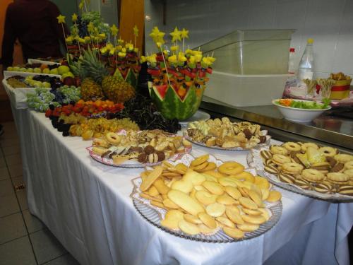 a table with several plates of food on it at Hotel Edelhof in Tarvisio