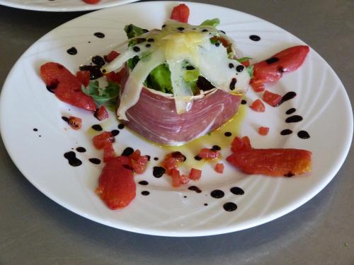 a plate of food with a ham and vegetables on it at Le Prieuré des Sources in La Répara